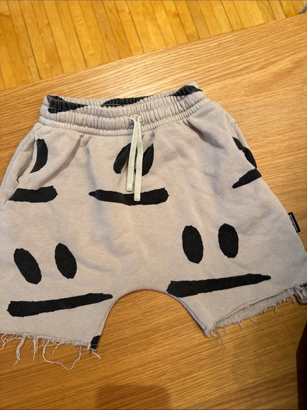 nununu Beige Shorts with Black Smile Graphics